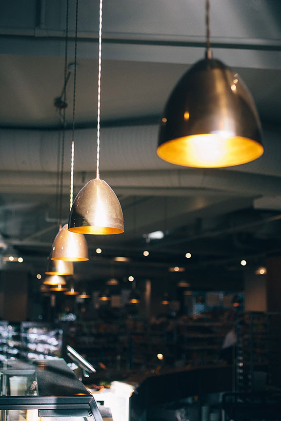 The tasteful Fallon & Byrne features our Skyler Industrial cone pendants